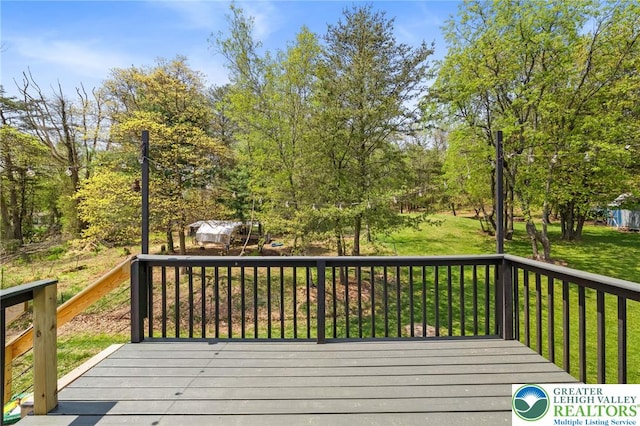 wooden deck with a lawn