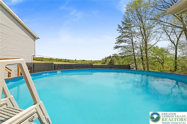 view of swimming pool with a fenced in pool and a fenced backyard