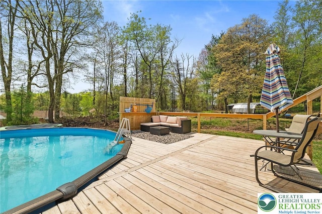 pool with a deck and an outdoor hangout area