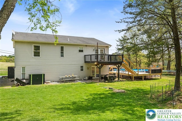 back of house featuring stairs, a yard, and a deck