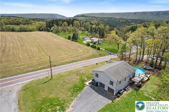 birds eye view of property with a mountain view and a rural view