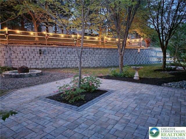 view of patio / terrace with fence and a fire pit