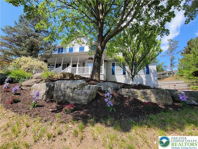 rear view of property with covered porch