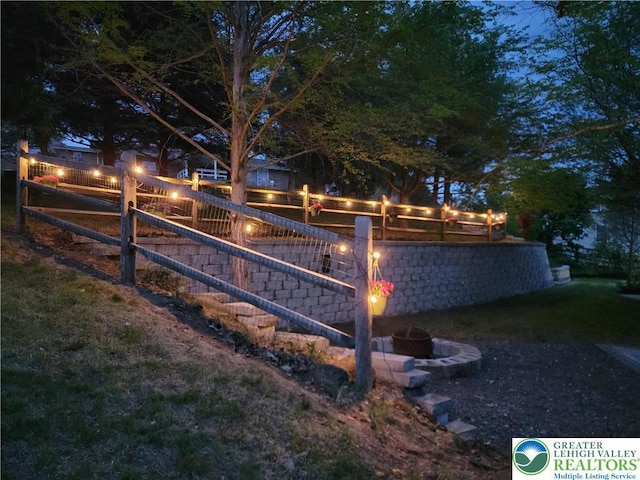 view of yard featuring fence and an outdoor fire pit