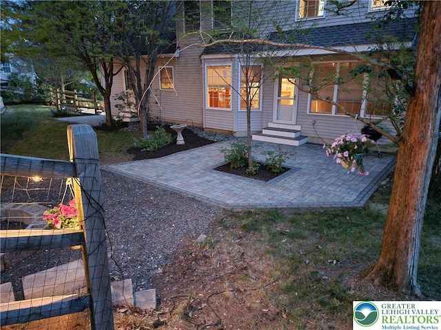 exterior space with a patio and a front lawn