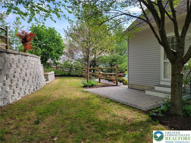 view of yard featuring fence and a patio area