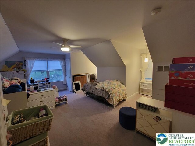 bedroom with carpet floors, visible vents, lofted ceiling, baseboards, and a ceiling fan