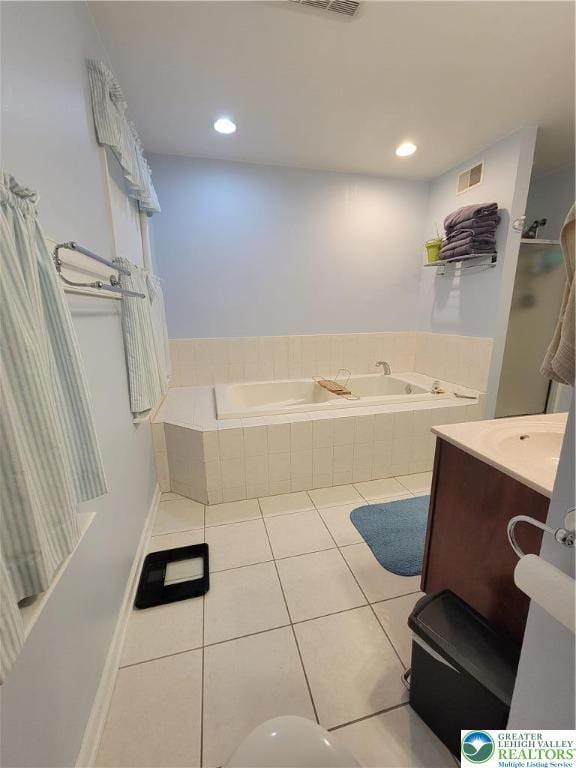 bathroom featuring vanity, tile patterned flooring, a garden tub, and visible vents