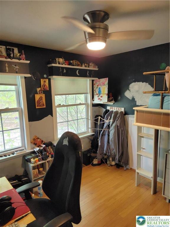 office with a ceiling fan and wood finished floors