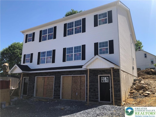 view of property with stone siding