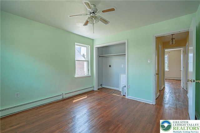 unfurnished bedroom featuring baseboards, a baseboard radiator, and wood-type flooring