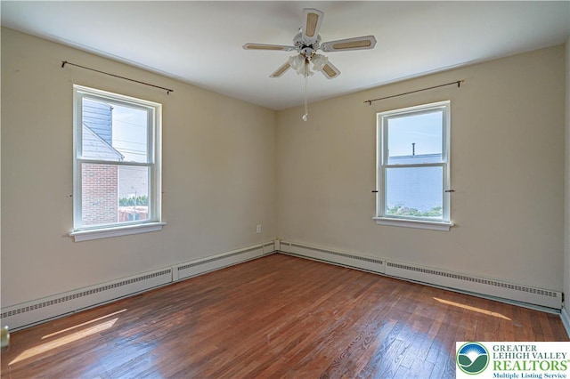 empty room featuring ceiling fan, hardwood / wood-style floors, and baseboard heating