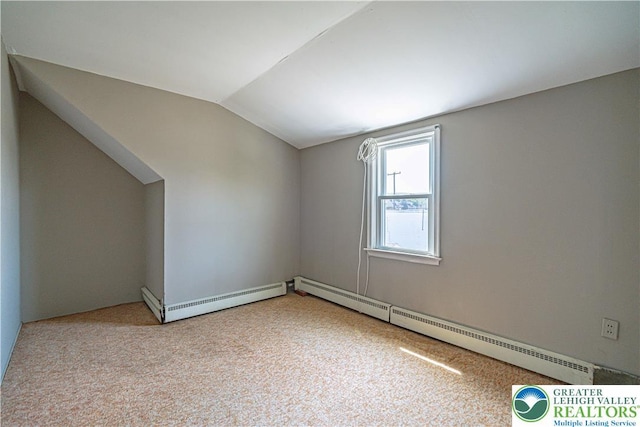 additional living space with vaulted ceiling, a baseboard radiator, a baseboard heating unit, and carpet floors