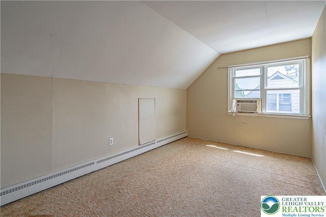 additional living space featuring a baseboard radiator, lofted ceiling, and carpet