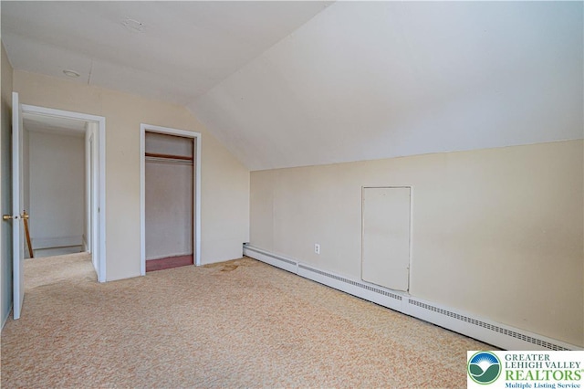 additional living space with baseboard heating, carpet floors, and vaulted ceiling
