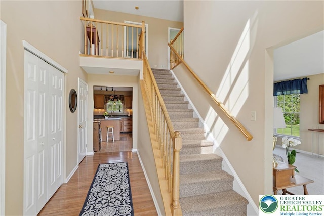 2735 Limeport Rd, Milford Twp, PA 18951 - foyer featuring baseboards, stairway, a towering ceiling, and wood finished floors