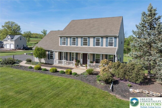 2735 Limeport Rd, Milford Twp, PA 18951 - view of front of house featuring a front lawn, roof with shingles, and covered porch