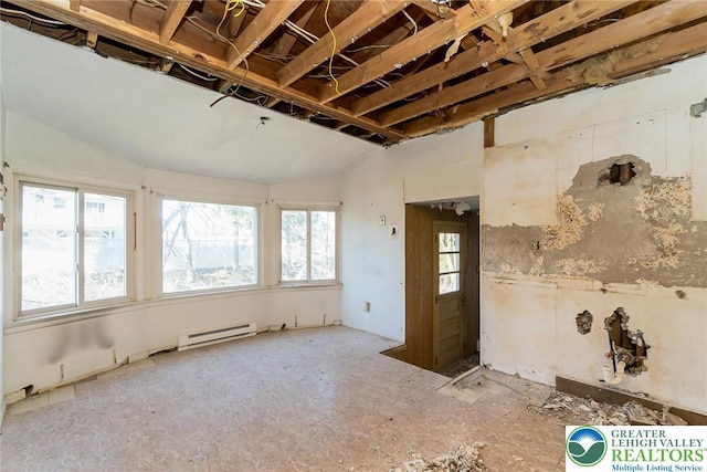 unfurnished room with lofted ceiling and a baseboard radiator