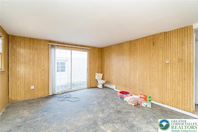 playroom with wooden walls and baseboard heating