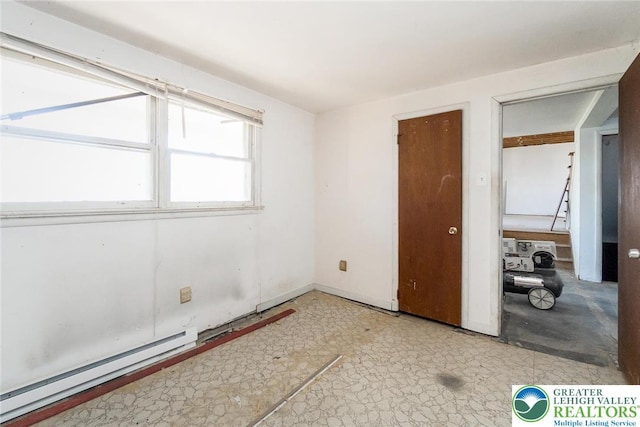 unfurnished bedroom with baseboard heating