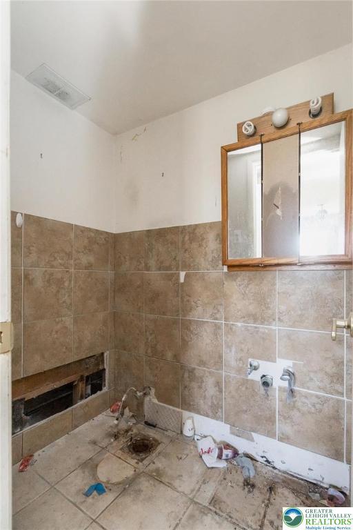bathroom with tile patterned flooring and visible vents