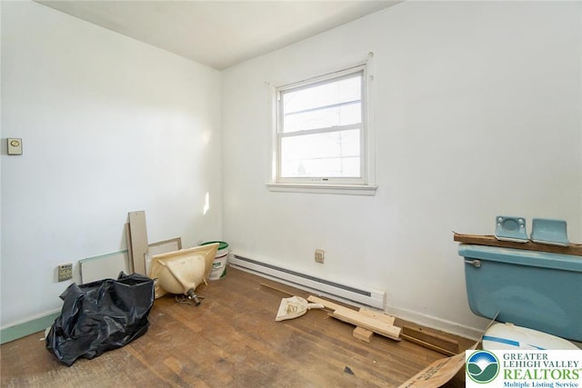 interior space with wood finished floors and baseboard heating