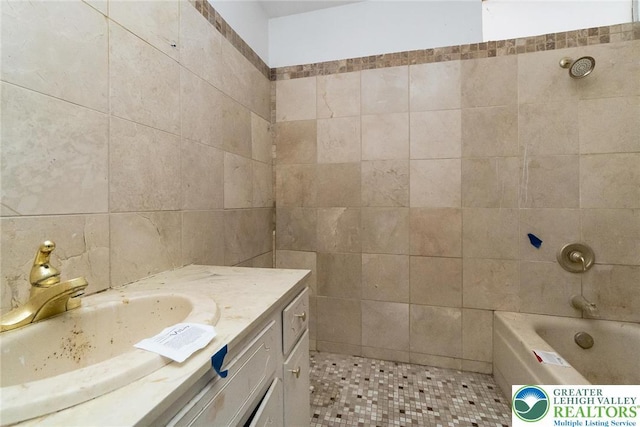 bathroom with vanity and tile walls