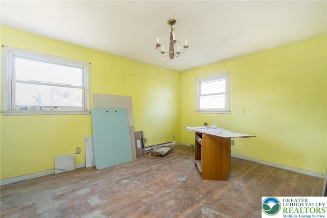 interior space with wood finished floors, a baseboard heating unit, and a notable chandelier