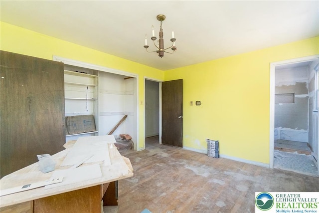 dining area featuring baseboards, a notable chandelier, and wood finished floors