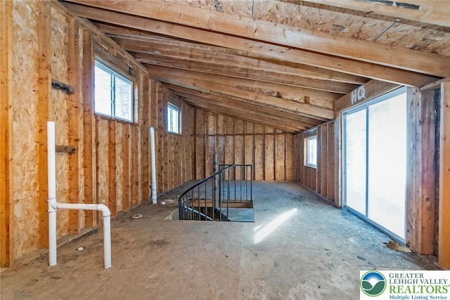 unfinished attic featuring an upstairs landing
