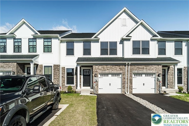 1022 Watson Ct, Upper Macungie Twp, PA 18051 - view of property featuring stone siding, driveway, a garage, board and batten siding, and a front yard