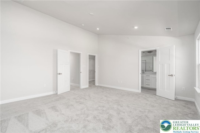 1022 Watson Ct, Upper Macungie Twp, PA 18051 - unfurnished bedroom with light colored carpet, a walk in closet, baseboards, recessed lighting, and connected bathroom