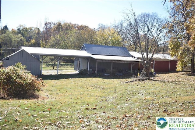 exterior space with a lawn and an attached carport