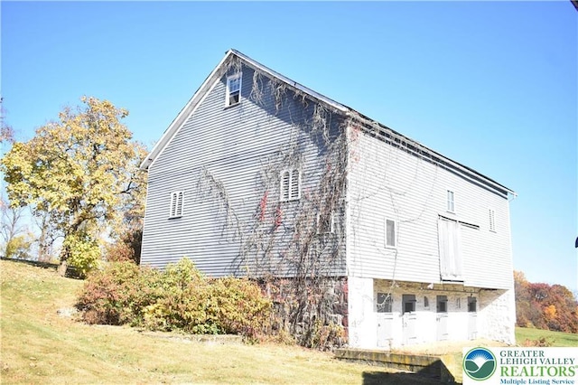 view of property exterior featuring a lawn