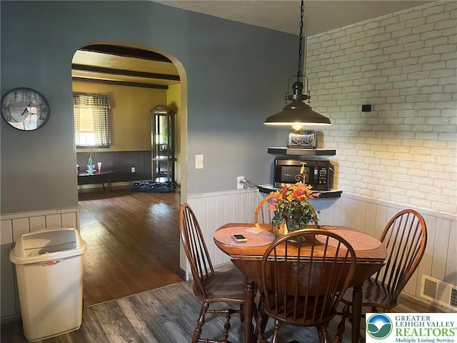 3426 Wilson Ave, South Whitehall Twp, PA 18069 - dining space with arched walkways, wainscoting, visible vents, and wood finished floors