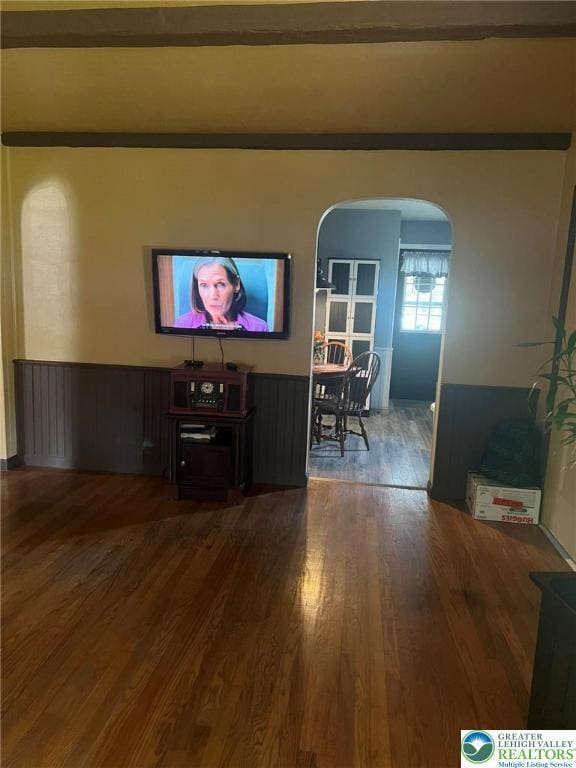 3426 Wilson Ave, South Whitehall Twp, PA 18069 - living area featuring arched walkways, wainscoting, and wood finished floors