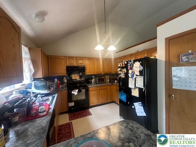kitchen featuring pendant lighting, range hood, black appliances, decorative backsplash, and lofted ceiling