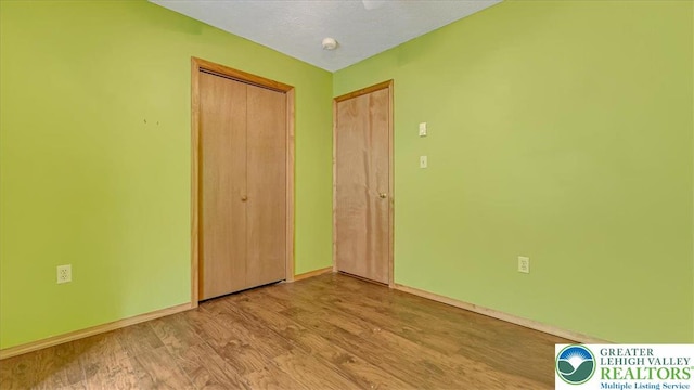 838 Cayuga Way, Stroud Twp, PA 18360 - unfurnished bedroom with wood finished floors and a closet