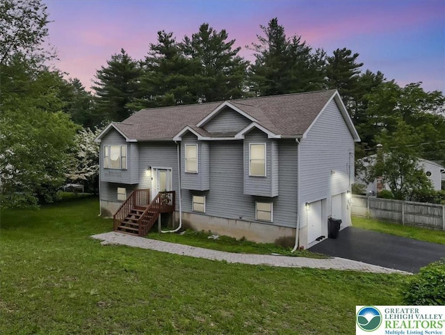 838 Cayuga Way, Stroud Twp, PA 18360 - bi-level home with driveway, a garage, and view of scattered trees