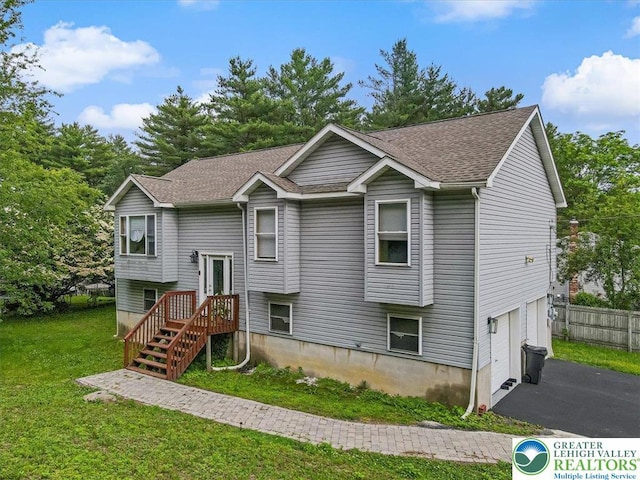 838 Cayuga Way, Stroud Twp, PA 18360 - split foyer home featuring a garage, a shingled roof, and asphalt driveway