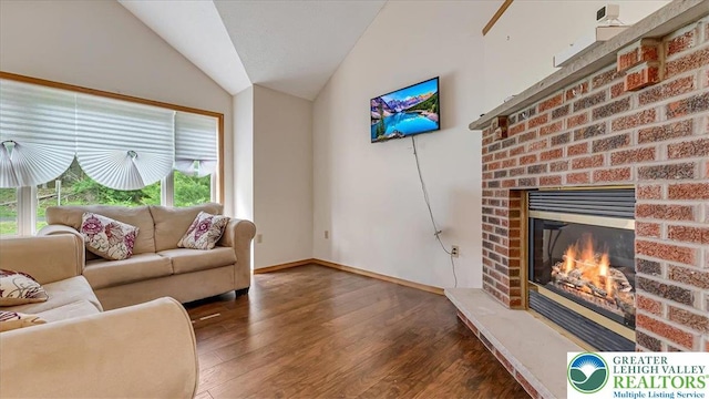 838 Cayuga Way, Stroud Twp, PA 18360 - living area featuring vaulted ceiling, wood finished floors, and a fireplace