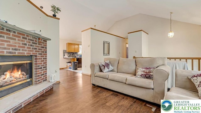 838 Cayuga Way, Stroud Twp, PA 18360 - living area featuring vaulted ceiling, wood finished floors, and a fireplace
