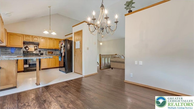 838 Cayuga Way, Stroud Twp, PA 18360 - kitchen with electric stove, freestanding refrigerator, wood finished floors, a chandelier, and under cabinet range hood