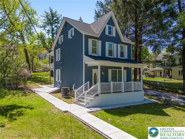 view of front of property featuring covered porch, roof with shingles, a front lawn, and central AC