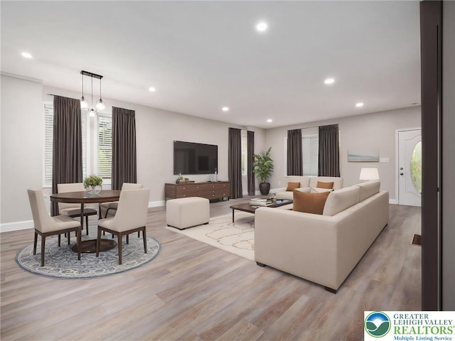 living room featuring baseboards, light wood-style flooring, and recessed lighting