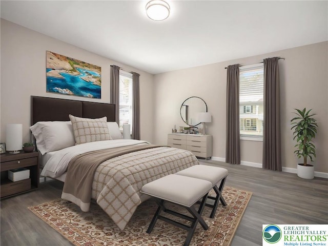 bedroom with baseboards and wood finished floors