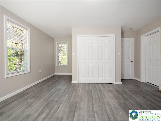 unfurnished bedroom featuring baseboards and wood finished floors