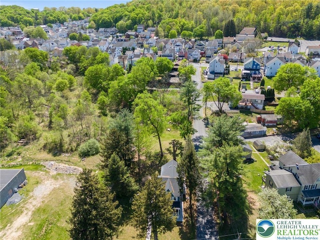 aerial view with a residential view and a view of trees
