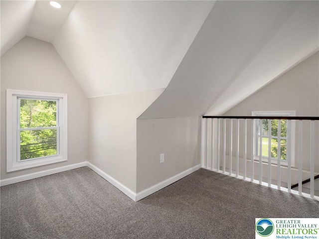 bonus room featuring baseboards, carpet, and vaulted ceiling