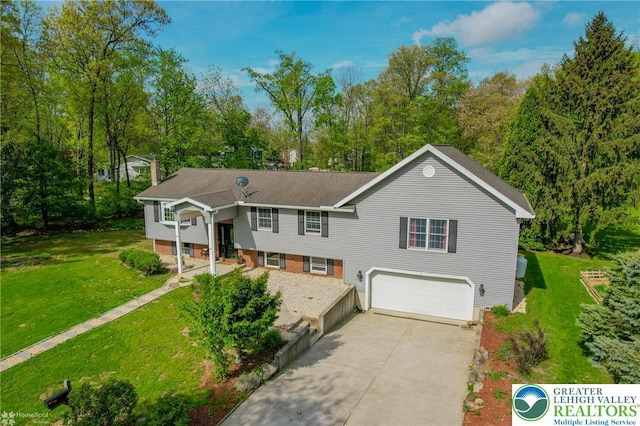 raised ranch featuring a garage, a front lawn, a chimney, and driveway